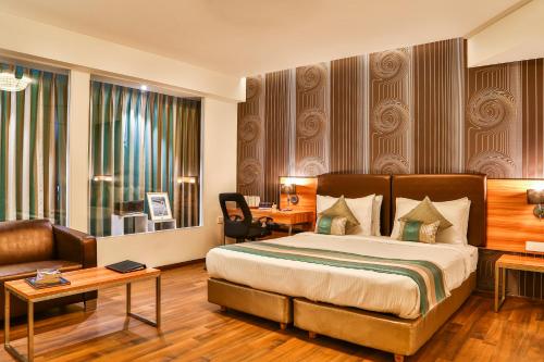Postel nebo postele na pokoji v ubytování T24 Residency Mumbai International Airport Hotel