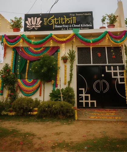a house with a black door and a sign on it at Atithi home stay and Cloud Kitchen in Ayodhya