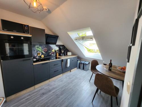 a kitchen with a table and a dining room at 3-room apartment with balcony in Northeim