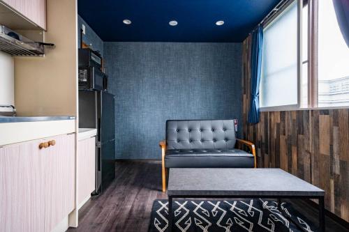 a room with a chair and a table in a kitchen at Silk Court 403 in Chitose
