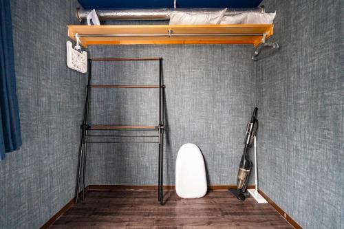 a room with a bed and a surfboard on the wall at Silk Court 403 in Chitose