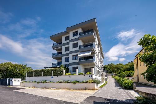 aominium building with a white fence in front of it at Seaview Apartment Kostrena Two - Happy Rentals in Kostrena