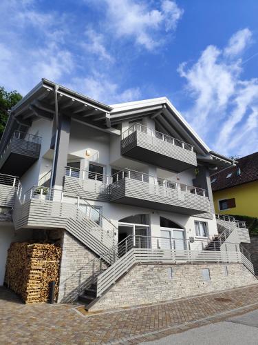 a white building with balconies and stairs on it at Maison 40 in Albiano