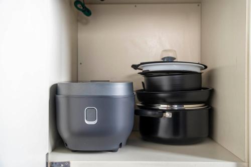 a shelf with some pots and pans in a drawer at Silk Court 403 in Chitose