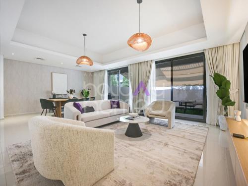a living room with a couch and chairs and a table at 4BR Luxurious Villa DAMAC Hills 2 in Dubai