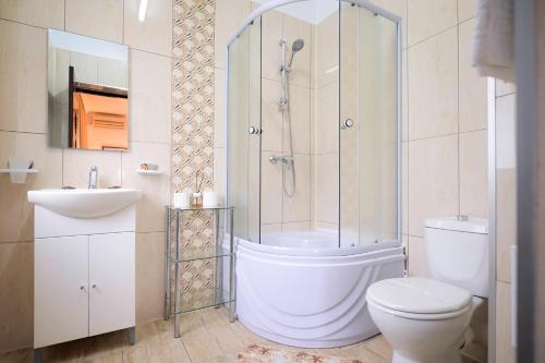 a bathroom with a shower and a toilet and a sink at Visconti Militari in Bucharest