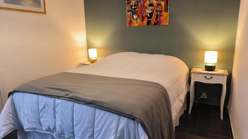- un petit lit dans une chambre avec deux lampes dans l'établissement St Cyprien appartement lumineux proche plage, à Saint Cyprien Plage