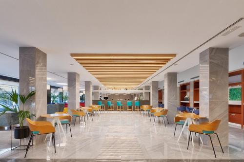 a cafeteria with tables and chairs in a building at Eurostars Puerto de Ibiza in Ibiza Town
