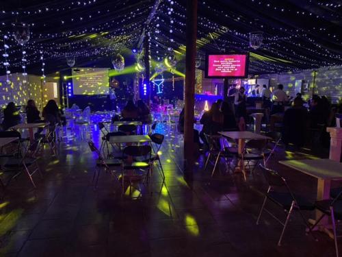 a group of tables and chairs in a room with lights at Rancho Benjamín Salazar in San Clemente