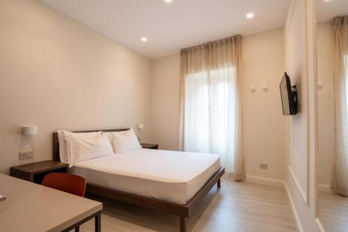 a hotel room with a bed and a window at Spazio Mari in Terracina