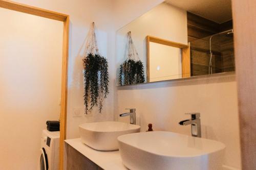 a bathroom with a white sink and a mirror at Villa Lagoon Paradise in Haapiti