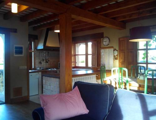 a living room with a couch and a kitchen at La Casuca de Margot in Agüero