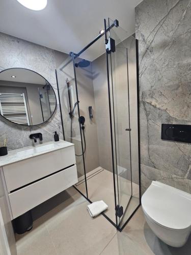 a bathroom with a shower and a toilet and a sink at Florek & Florica Apartment in Križevci