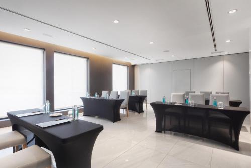 a waiting room with black tables and chairs at Eurostars Puerto de Ibiza in Ibiza Town