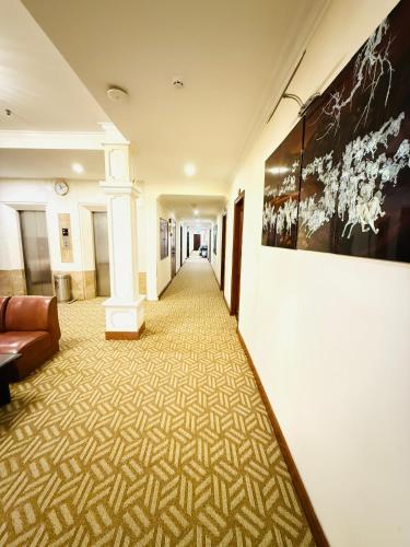 a hallway with a couch and a painting on the wall at Huong Sen Hotel in Ho Chi Minh City