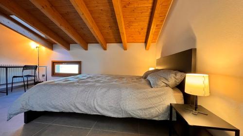 a bedroom with a bed and a table with a lamp at B&B La Collina in Casina