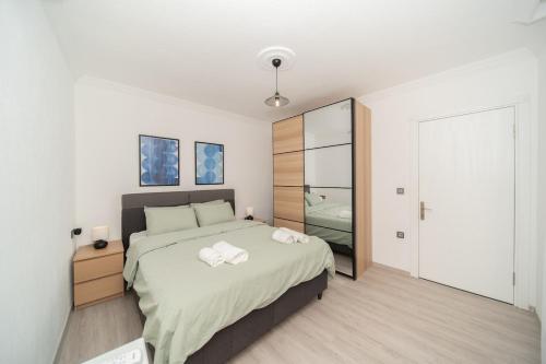 a bedroom with a bed with two towels on it at Bodrum Center 2 Bedroom Calm Modern Upstairs Flat - Yeni Dünya Bodrum in Bodrum City