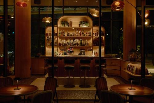 a bar with wooden tables and chairs in a restaurant at The Standard, Singapore in Singapore