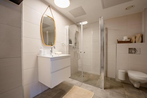 a bathroom with a toilet and a sink and a mirror at Maui Apartment-By Harim in Eilat