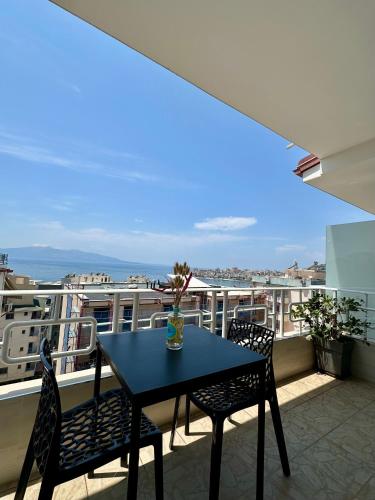 a table and chairs on a balcony with a view at Jericho rooms in Sarandë