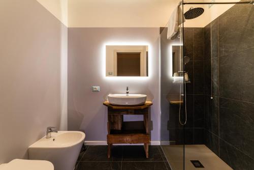 a bathroom with a sink and a shower at Lussari Style Apartments in Camporosso in Valcanale