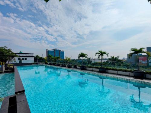 a large swimming pool on the roof of a building at Grand Zuri Cikarang Jababeka in Cikarang