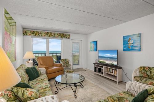 a living room with a couch and a tv at Edgewater Condo Unit #303 Apts in South Padre Island