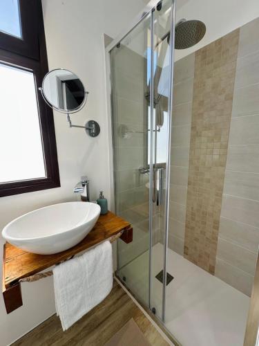 a bathroom with a sink and a glass shower at Pozzallo sea house in Pozzallo