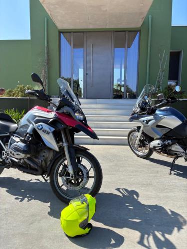 two motorcycles parked in front of a building at FinIQ Boutiq Studios in Foiníki