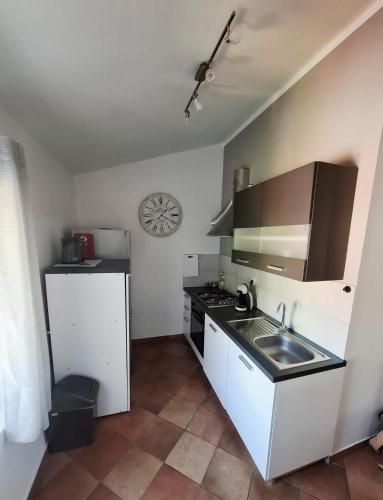 a small kitchen with a sink and a stove at Bay view apartment in Bakar