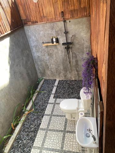 a small bathroom with a toilet and a sink at Pondok Punaga in Jasri