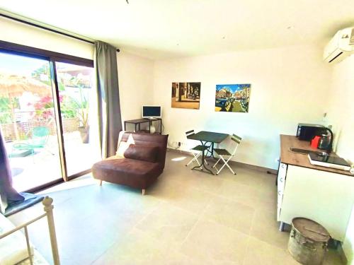 a living room with a couch and a table and a desk at Oceanfront apartment in Premiá de Mar