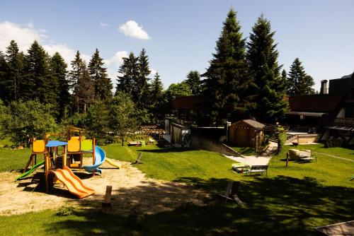 a park with a playground with a slide at "Park Hotel Ela" in Borovets