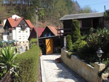 a house with a garden and a street with houses at Haus 'Annelies' in Kurort Rathen