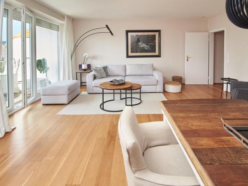 a living room with a couch and a table at Techts Apartmenthaus in Timmendorfer Strand