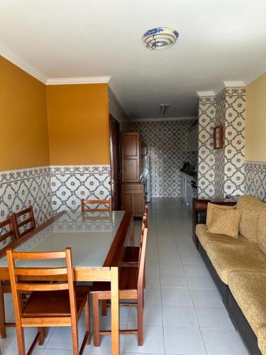 a living room with a table and a couch at Apartamento da praia in Ovar