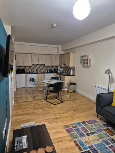 a living room with a table and a kitchen at Wexford Quayfront Apartments 1, 2, 3 & 4 in Wexford