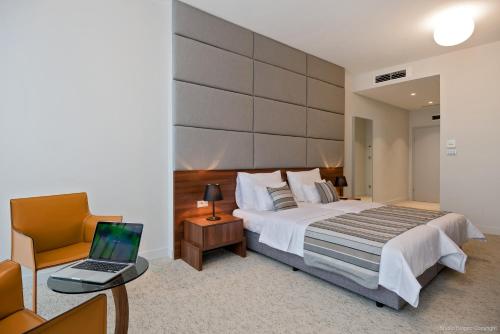 a bedroom with a bed and a laptop on a table at Priska Med Luxury Rooms in Split