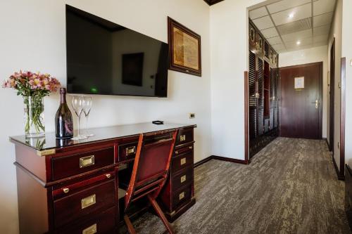a room with a dresser with a bottle of wine at Boutique Hotel Nautica - SPA & wellness, FREE Parking, Pet friendly in Novigrad Istria