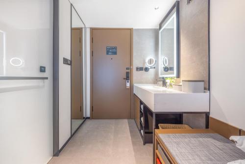a bathroom with a sink and a mirror at Atour Hotel Beijing Sanlitun North Gongti Road in Beijing