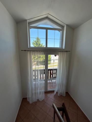 an empty room with a window and a balcony at Penzión Nezábudka in Stropkov