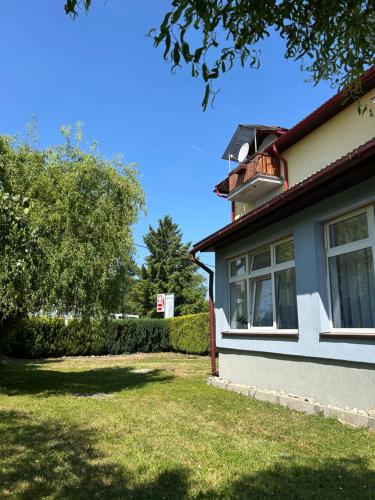 a house with a yard next to a building at Penzión Nezábudka in Stropkov