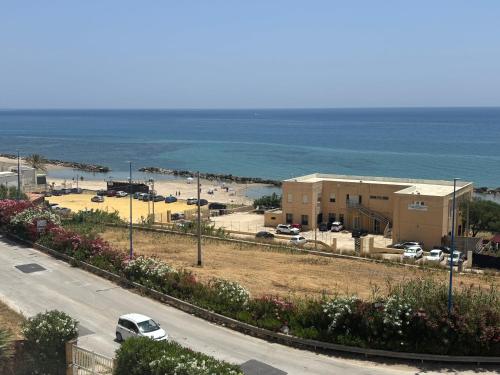 a view of a parking lot next to the ocean at Casa Lido in Sciacca