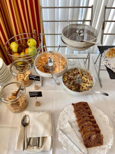 a table with many plates of food on it at Hotel Olivo in Arco