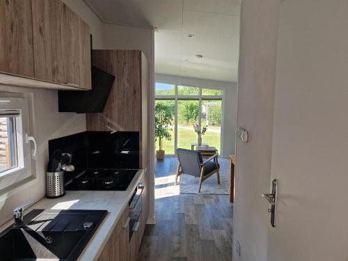 a kitchen with a sink and a counter top at Camping Alkenhaer Appelscha Chalet 017 in Appelscha