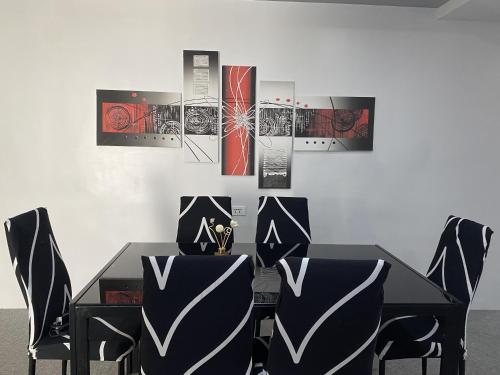 a dining room with a black table and chairs at Lalaguna Villas Luxury Dive Resort and Spa in Puerto Galera