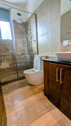 a bathroom with a toilet and a sink and a shower at Royal Lion Hotel - Kandy Road, Galagadara in Galagedara
