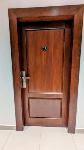 a wooden door with a sign on it at Royal Lion Hotel - Kandy Road, Galagadara in Galagedara