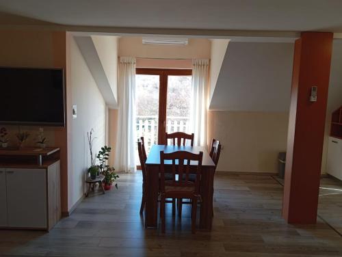 a kitchen and dining room with a table and chairs at Apartment Krupa u srcu in Krupa