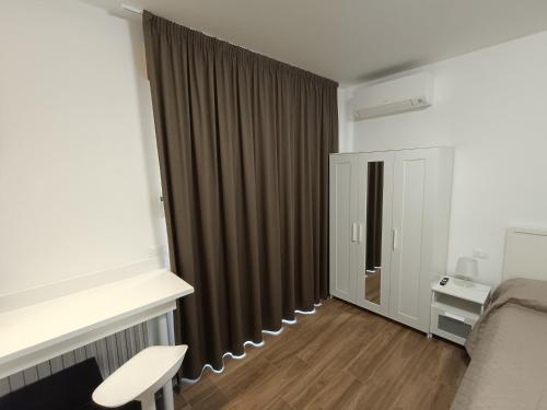 a room with a bed and a window with curtains at Casa Degli Ulivi - Camera in Numana